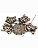 Sea turtle 2‑hole slider beads in mixed metallic finishes—antique silver, brass, and copper—bring coastal charm to jewelry designs. Each bead features a smooth, raised shell with defined flippers and balanced dual holes for clean double‑strand alignment. Perfect for beach‑themed bracelets, chokers, or boho anklets celebrating ocean life and natural beauty.
