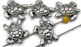 Antique silver turtle 2‑hole slider beads with lifelike detail and polished texture. Designed for flat, even placement in double‑strand jewelry, they function beautifully as bracelet spacer bars or centerpiece connectors. Perfect for coastal jewelry collections, these beads honor sea life with symbolic charm, representing calm, wisdom, and perseverance.