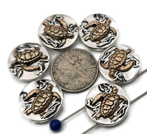 These sea turtle 2‑hole slider beads feature a raised copper turtle design on an antique silver base, creating beautiful mixed‑metal contrast. Perfectly made for double‑strand bracelets, chokers, or necklaces, they align flat and securely. Add them as focal sliders, spacers, or connectors for boho, ocean, or coastal jewelry. Sold in sets of six for easy design planning.