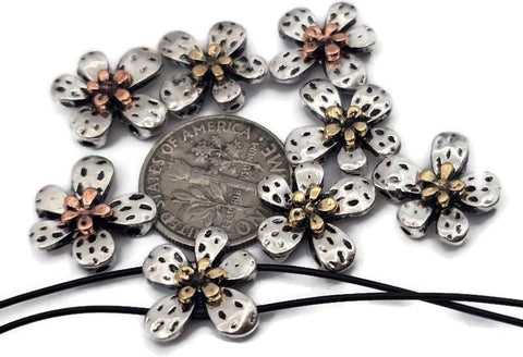 These bright silver flower 2‑hole slider beads feature layered petals with warm copper and gold centers for a stunning mixed‑metal effect. The reflective finish and dual threading holes make them perfect for double‑strand bracelets, chokers, or necklaces. Lightweight yet detailed, they add floral sophistication to boho, romantic, or nature‑inspired jewelry designs.