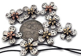 Shiny silver floral 2‑hole slider beads with gold and copper accents bring elegant charm to any jewelry project. Their raised, layered petals and metallic shimmer create a sculptural focal point. Ideal for bracelets, chokers, or double‑strand cuffs highlighting feminine and handcrafted style. Perfect for spring, wedding, or garden‑inspired creations.