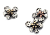 These mixed‑metal 2‑hole slider beads feature dimensional five‑petal flowers with bright silver petals and golden or copper centers. Designed for even spacing in double‑strand jewelry, they work beautifully as spacers or focal beads. Their light weight and high‑shine finish give coastal, bohemian, and romantic designs refined metallic detail.