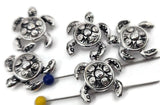 These detailed silver turtle 2‑hole slider beads combine craftsmanship and symbolism. The raised shell patterns and gleaming finish evoke seawater’s shimmer. Easily aligned for double‑strand jewelry, they make standout focal beads or spacers for beach and boho collections celebrating peace and enduring strength.