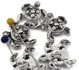 Silver sea turtle 2‑hole slider beads featuring embossed spiral shells and shiny reflective surfaces. Durable yet lightweight, they provide symmetrical spacing for double‑strand bracelets. Perfect for expressing ocean serenity and natural harmony in coastal, boho, or casual jewelry inspired by beach life.