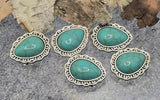 Teardrop turquoise-look 2-hole slider beads for bracelets and necklaces. Antique silver setting with scrollwork adds vintage Western flair. Two channels thread over leather or bead-woven strips for centered placement that won’t spin. Great focal beads, bracelet beads, and necklace beads for jewelry making. Ideal beads for beading hatbands, boot bracelets, and bolo tie accents.