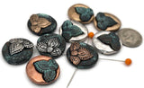 Discover versatile metal 2‑hole slider beads in a captivating mix of silver, gold, copper, and verdigris patina. These focal beads feature intricate floral designs, perfect for adding a touch of boho chic or rustic charm to your jewelry. Use them as bracelet connectors or central elements in multi‑strand necklaces. Their dual holes ensure easy stringing and a professional finish for all your jewelry making supplies.