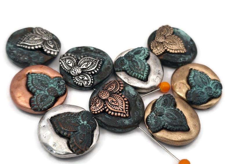 Elevate your designs with these artisan metal 2‑hole focal beads, showcasing a beautiful blend of silver, gold, antique copper, and teal patina finishes. Each bead boasts a detailed floral motif, making them ideal for mixed‑metal jewelry projects. As double‑hole slider beads, they provide excellent stability for wide bracelets and cuffs, adding a unique, handcrafted touch to your beading supplies.