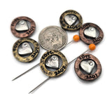 These LOVE heart 2‑hole slider beads are the perfect addition to your jewelry supplies. Made from durable metal with rustic gold and copper tones, engraved lettering, and a bright rhinestone accent, they make beautiful focal beads for bracelets and necklaces. Pair with rondelle beads, glass pearls, or seed beads to create unique expressions of affection in handmade jewelry. Perfect for crafting, beading, and DIY jewelry making.