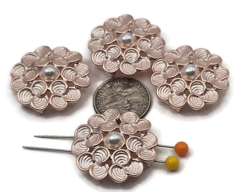 Floral 2 hole slider beads in bright gold metal with soft blush enamel and a pearl‑style center. These metal beads make easy bracelet focals, pendant connectors, and earring centers. Use as slider, spacer, filler, or connector components in jewelry making, beading, and crafting. Pair with seed beads, bugle, gemstone chips, pearls, crystals, Czech glass, and other metallic beads to build balanced designs. Great beading supplies and findings for DIY makers and small wholesale.