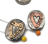 Meaningful and modern: 2 hole slider beads in light pewter with copper and gold heart overlays and “LOVE” engraving. Treat them as slide spacers or connectors to join bead‑woven bands to chain, or center one on a bracelet with seed beads and metallic fillers. Great for friendship gifts, bridal parties, and everyday stacks. Essential beading components, metal beads, and findings for jewelry making supplies shoppers.