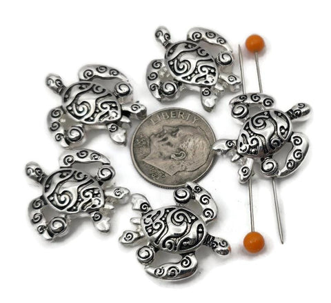 Bright silver turtle 2 hole slider beads for jewelry making, beading, and crafting. These metal beads create an easy ocean focal, spacer, or connector in a bracelet, pendant necklace, or earrings. Pair the sea turtle slider with seed beads as filler beads, beach gemstones (howlite, jasper, amazonite), pearls, crystals, or other metallic beads to finish coastal designs. Fun beading components and findings for summer stacks, gifts, beach weddings, and small‑batch wholesale.