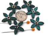 These teal patina floral 2 hole slider beads bring bold color and organic texture to bracelets and necklaces. Use as a focal slider, slide spacer, or connector component; add seed beads, bugle, pearls, crystals, or gemstone chips as space fillers to complete the layout. The metallic center adds a subtle sparkle. Reliable beading findings for makers who love floral beads and mixed‑metal palettes.