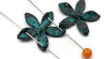 Design garden‑inspired bracelets with teal flower 2 hole slider beads. Treat the metal floral as a connector between bead‑woven straps or simple stringing, then frame with seed beads and metallic spacers to set spacing. Great as pendant focals and lightweight earring centers. The antiqued teal finish mixes beautifully with copper, silver, and gold. Versatile beading components and jewelry making supplies for crafting gifts, bridal parties, and everyday wear.