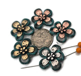 These dimensional flower sliders bring instant movement to your projects. Seat one at bracelet center, repeat as a pendant connector, and finish with matching earring drops. Pair the turquoise‑patina frames with amazonite, jasper, hematite, pearls, and crystals; add tiny metallic spacers to echo the petal finishes. Practical 2 hole slider beads, beading components, and findings for gift‑ready sets.