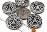 Statement rounds made simple: silver spiral 2 hole slider beads with geometric edging. String between seed beads for balanced spacing or connect bead‑woven straps directly into the dual channels. Coordinate with pewter spacers, heishi, and Czech glass to complete the layout. Must‑have metal beads and connector components for boho and Southwestern collections.