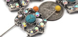 Add a bold, colorful centerpiece to your designs with these turquoise and rhinestone 2‑hole slider beads. The dual channels stabilize two strands so the large focal stays centered on cuffs, chokers, and hatbands. Mix with seed beads, crystal bicones, and silver spacer beads for a layered, Southwestern aesthetic. Ideal bracelet beads, necklace beads, and beading findings for those who want a sophisticated, high‑impact focal for their jewelry.