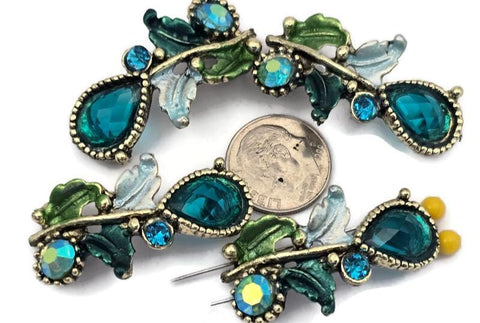 These ornate 2 hole slider beads feature large blue zircon teardrop stones with AB coating, accented by smaller blue rhinestones and decorative metal leaf details. Perfect as focal beads for bracelets and chokers, the double‑hole design keeps two strands of leather, cord, or beading wire aligned and centered. Pair with seed beads, Czech beads, crystals, or gemstone chips for glamorous designs. Beautiful bracelet beads and jewelry making components for boho and statement jewelry.