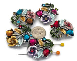 These gemstone‑colored floral 2 hole slider beads feature faceted stones in ruby, sapphire, amethyst, and emerald tones, paired with hand‑painted enamel flowers and silver metal leaves. Perfect as focal beads for bracelets and chokers, the double‑hole design keeps two strands of leather, cord, or beading wire aligned and centered. Pair with seed beads, Czech beads, and crystal accents for vibrant garden‑inspired designs.