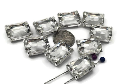 These emerald‑cut 2 hole slider beads feature a large, faceted resin stone in a silver‑tone prong setting. Perfect as focal beads for bracelets and chokers, the double‑hole design keeps two strands of leather, cord, or beading wire perfectly aligned. Pair with seed beads, Czech beads, and pearls for a high‑end look without the weight. Durable jewelry making components and bracelet beads that add instant style to any beading project.