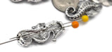 Design meaningful coastal jewelry with platinum silver seahorse beads. Each 2‑hole slider showcases sculpted fins and segmented body detail, making them standout focal beads or repeating slide beads. The parallel holes function as a spacer bar for tidy double‑strand layouts. Combine these sea life beads with turquoise, aquamarine‑look crystals, pearls, heishi, and tribal silver spacers for beach, mermaid, and ocean‑inspired bracelets and necklaces.