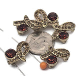 Add rich sparkle to your designs with these gold 2‑hole slider beads in an elegant ribbon / bow design. Each focal connector features a larger deep smoked topaz (topaz‑brown) crystal paired with rows of coordinating champagne‑topaz rhinestones for a luxe, vintage look. The two‑hole layout keeps strands aligned for multi‑strand bracelets and necklaces. Pair with seed beads, gemstone beads, or pearls for stunning handmade jewelry.