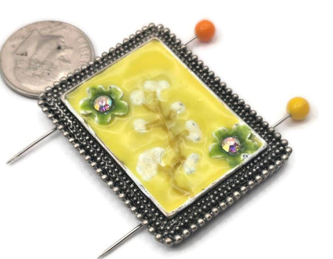 This antique silver floral slider bead is the perfect focal piece for your next project. The vibrant yellow enamel and raised floral details create a beautiful 3D effect, while the two-hole design provides stability for bracelet and necklace designs. Use it as a connector with seed beads, crystals, or leather cord to craft one-of-a-kind artisan jewelry. A durable and artistic addition to your jewelry making supplies and crafting toolkit.