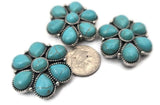 These concho‑style turquoise 2‑hole slider beads feature a bold floral cluster design perfect for Western bracelets and chokers. The double‑hole construction keeps strands parallel and the focal centered. Mix with seed beads, crystal accents, Czech beads, or turquoise chips for layered designs. Must‑have bracelet beads, necklace beads, and jewelry making beads for Southwestern and boho collections.
