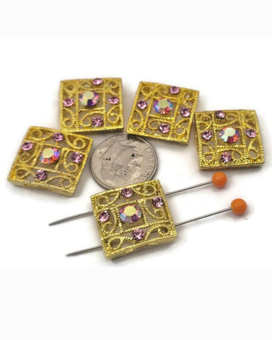 Add instant sparkle to bracelets and necklaces with these gold 2‑hole slider beads featuring an elegant filigree design and dazzling rose rhinestone crystals. The center stone has a brilliant AB coating for rainbow flash and high‑end shine. Use these metal focal beads as connectors in multi‑strand projects or as statement accents with seed beads, gemstone beads, and spacers. Perfect jewelry making supplies for glamorous, feminine designs.