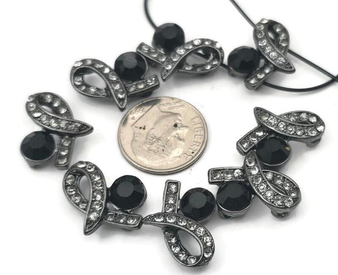 Add a touch of gothic glamour with these gunmetal 2‑hole slider beads in a sophisticated ribbon design. Each focal connector features a large, faceted jet black rhinestone paired with shimmering black diamond (smoky grey) crystals. The two‑hole layout is perfect for multi‑strand bracelets and necklaces, keeping strands aligned and secure. Pair with seed beads, gemstone beads, or pearls for stunning, high‑contrast handmade jewelry and artisan crafts.