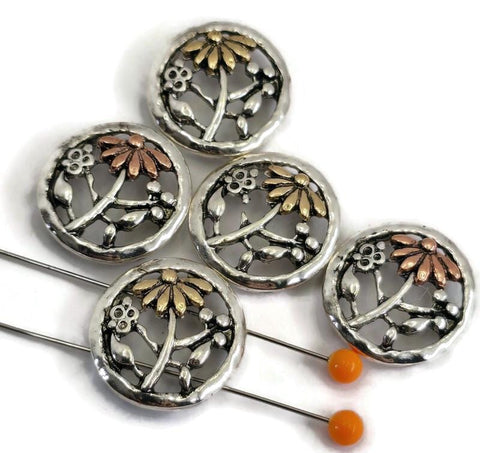 Add botanical charm to your designs with these round floral 2‑hole slider beads. Featuring an openwork flower and branch motif with two‑tone petals in warm brass and copper accents on a silver‑tone base, they’re perfect as connectors for multi‑strand bracelets and necklaces. The two-hole layout keeps strands aligned and flat. Pair with seed beads, gemstone beads, or pearls for vintage, boho, and cottage‑style jewelry making.