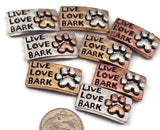 These Live Love Bark paw print 2 hole slider beads are perfect metal spacer beads for two strand double jewelry designs. Use them with seed beads, duo beads, or other spacer filler beads to create beautiful bracelets or necklaces. The mixed metal antique detailing in silver, gold, and copper gives these jewelry making components a rustic look that works wonderfully for dog lover jewelry, pet themed bracelet designs, and DIY crafting beading supplies.