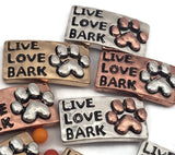 These adorable paw print 2 hole slider beads feature the phrase Live Love Bark and antique metal detailing in silver, copper, and gold tones. Designed as metal slide spacer beads for double strand bracelets and necklaces, they pair well with seed beads, duo beads, and other jewelry spacer beads. Perfect for dog lover jewelry, pet themed bracelet making, and unique DIY beading designs.