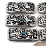 These western style 2 hole slider beads feature a turquoise colored center stone with detailed southwestern patterning in antique silver metal. Designed as metal slide spacer beads for double strand bracelet and necklace jewelry making, they work perfectly between seed beads, duo beads, gemstones, or leather cords. Ideal for western jewelry designs, rustic bracelet making, boho jewelry projects, and DIY beading supplies.