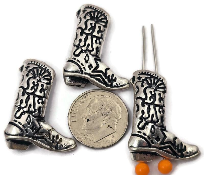 Add a fun western touch to your jewelry designs with these detailed Yee Haw cowboy boot 2-hole slider beads. Featuring intricate boot stitching, western motifs, and the words “Yee Haw,” these metal slider beads are perfect for double-strand bracelets, necklaces, and rustic jewelry projects. Designed with two holes on the back, they work beautifully with cord, leather, or wire. Ideal for country-inspired jewelry, rodeo themes, and western style accessories.