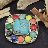 Add dramatic western flair to your jewelry with this large southwestern two hole focal bead. The 43 mm square design features a bold turquoise style center stone framed by colorful enamel accents in a decorative metal setting. Sold individually, this bead is perfect for statement bracelets, necklaces, and double strand jewelry designs. Ideal for western jewelry makers creating cowgirl accessories and southwestern inspired handmade jewelry.