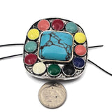 This large 43 mm southwestern statement bead is designed to be the centerpiece of bold handmade jewelry. The square turquoise style center is surrounded by colorful enamel accents that create a vibrant western look. Sold individually, this oversized two hole slider bead is perfect for double strand bracelets, leather jewelry, or statement necklaces. Ideal for cowgirl jewelry, western accessories, and colorful southwestern jewelry designs.