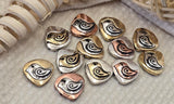 These boho mixed‑metal heart beads are perfect for jewelry makers who love texture and vintage style. With a raised spiral motif and antiqued silver, brass, and copper tones, they work beautifully as focal beads or bold spacers. Mix them with seed beads, pearls, or gemstone beads to create bracelets, necklaces, and charm jewelry. Ideal for crafting, wire wrapping, beading projects, and romantic handmade designs.