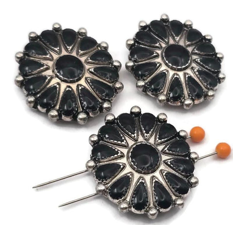 These detailed western floral focal beads feature a bold round concho design with black enamel accents and antique silver tone finish. Perfect for use in double strand bracelets and necklaces, the two hole construction keeps your design balanced and centered. Pair with leather cord, gemstone beads, or seed beads to create western jewelry, cowgirl accessories, and rustic handmade statement pieces.