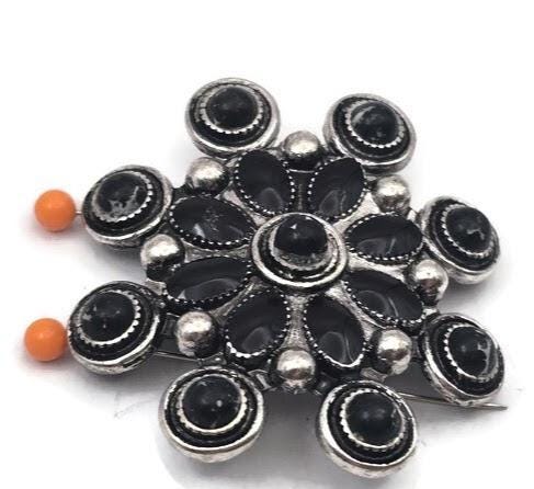 Add bold western style to your jewelry with these concho cluster slider beads. The intricate floral design with black enamel accents and antique silver finish creates a striking focal bead. Designed with two holes for double strand bracelets and necklaces, they work beautifully with leather cord, seed beads, and natural stones. Perfect for cowgirl jewelry, western accessories, and artisan statement jewelry designs.