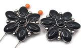 These beautiful black concho style slider beads feature a floral design with oval shaped accents surrounding a raised center. The bold black color and antique silver tone create a classic western look. Designed with two holes on the back, they are perfect for double strand bracelet projects and layered necklaces. A great choice for cowgirl jewelry, western accessories, and rustic handmade jewelry designs.