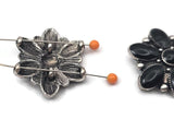 These striking western floral slider beads feature smooth black accents arranged in a bold flower pattern with antique silver tone detailing. Designed with two holes for double strand jewelry, they make beautiful focal beads for bracelets and necklaces. Pair with leather cord, seed beads, or natural stones to create western jewelry, cowgirl accessories, and rustic handmade designs.