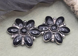 Bring bold contrast to your jewelry designs with these black floral concho slider beads. The petal shaped design and antique silver tone finish create a strong focal bead for handmade jewelry. The two hole construction makes them perfect for double strand bracelets and necklaces. Ideal for western jewelry, cowgirl accessories, boho designs, and statement handmade jewelry pieces.