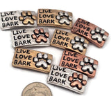 Add personality to your designs with these 2 hole slider beads featuring a Live Love Bark paw print motif. These metal slide spacer beads work perfectly for double 2 strand bracelet necklace designs using seed beads, duo beads, or other beading components and findings. With antique style detailing in silver, copper, and gold metals, they are wonderful for dog lover jewelry, pet themed DIY beading projects, and unique bracelet making supplies.