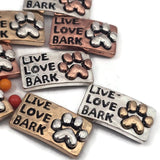 These 2 hole slider beads with Live Love Bark paw print design are wonderful metal slide spacer beads for double 2 strand jewelry designs. Use them in bracelets or necklaces alongside seed beads, duo beads, or other spacer filler beads. The antique mixed metal look in silver, gold, and copper makes them perfect for dog lover jewelry, pet themed bracelet making, and creative jewelry crafting supplies.