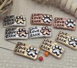 Create unique pet themed jewelry with these Live Love Bark paw print 2 hole slider beads. These metal slide spacer beads are perfect for double strand bracelet necklace designs and work beautifully with seed beads, duo beads, and other jewelry making components and findings. The antique mixed metal finish in silver, copper, and gold makes them ideal for dog lover jewelry, DIY beading projects, and creative jewelry supplies.