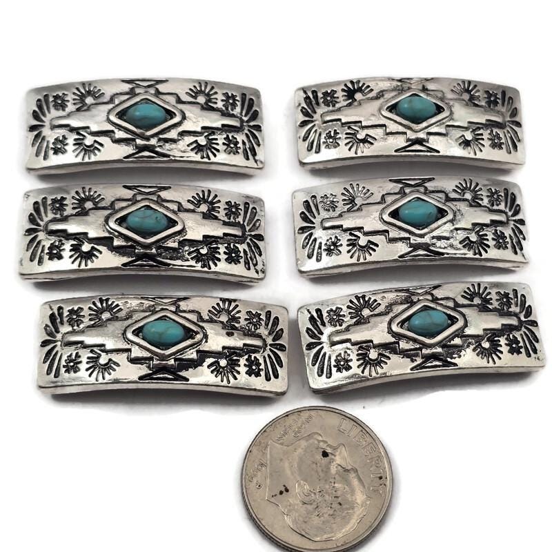 2 hole slider beads with western turquoise style design in antique silver metal with a turquoise colored center stone. These metal slide spacer beads are perfect for two strand double bracelet and necklace jewelry making, pairing beautifully with seed beads, duo beads, gemstone beads, and leather cord. Ideal for western jewelry, boho bracelet designs, southwestern style jewelry, and DIY beading projects, these unique jewelry making components and findings.