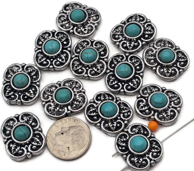 2 hole slider beads with western turquoise flower design in antique silver metal with turquoise style center stones. These metal slide spacer beads are perfect for two strand double bracelet and necklace jewelry making, pairing beautifully with seed beads, duo beads, gemstone beads, and leather cord designs. Ideal for western jewelry, cowgirl bracelet designs, southwestern style accessories, and DIY beading projects, these unique jewelry making components and findings.