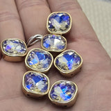 These clear AB rhinestone square 2 hole slider beads feature a stunning aurora borealis stone in a warm gold bezel setting. Color-shifting unique findings perfect for bohemian jewelry, festival accessories, and statement bracelets. Use these double hole spacer beads in bead weaving, stringing, and wire wrapping. Compatible with CzechMates, SuperDuo, and other two hole bead designs.