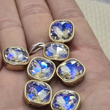 These iridescent aurora borealis square 2 hole slider beads in gold bezel setting are show-stopping unique findings for any jewelry collection. Color-shifting rhinestone spacer beads perfect for bohemian designs, statement bracelets, and layered necklaces. Use in wire wrapping, stringing, and bead weaving alongside SuperDuo, CzechMates, and carrier bead components.