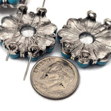 Add sparkle to your designs with these AB crystal 2 hole slider beads surrounded by round turquoise beads in antique silver metal settings. The faceted rhinestone center reflects rainbow colors, making these beads a bold focal component. These metal slide spacer beads are ideal for double strand bracelet and necklace jewelry making and pair beautifully with seed beads, duo beads, gemstone beads, and leather cord jewelry designs.